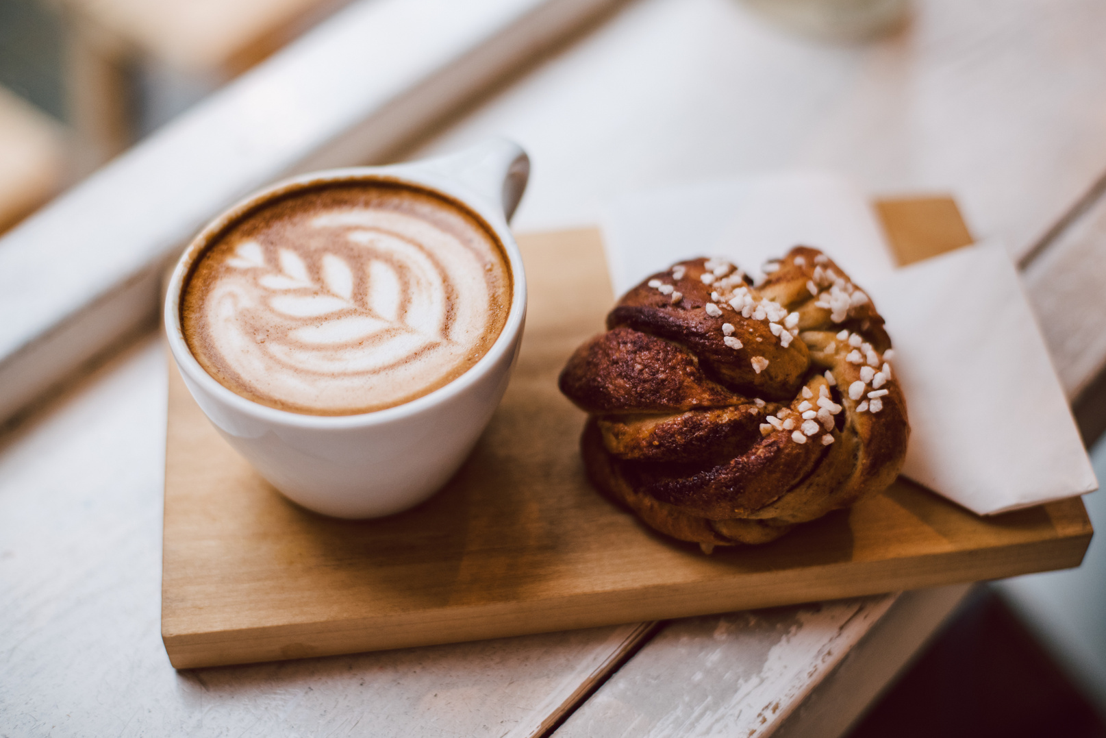 Cappuccino placed beside the window